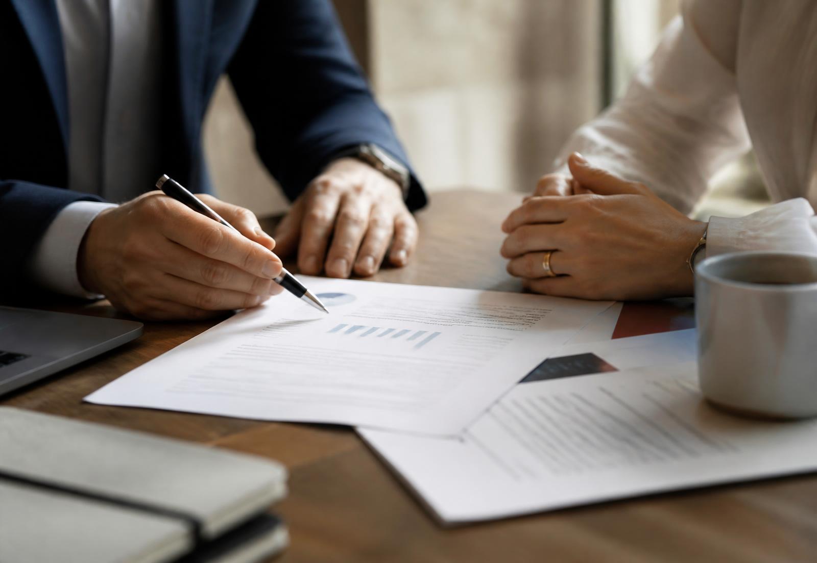 An advisor talking with a couple across a table